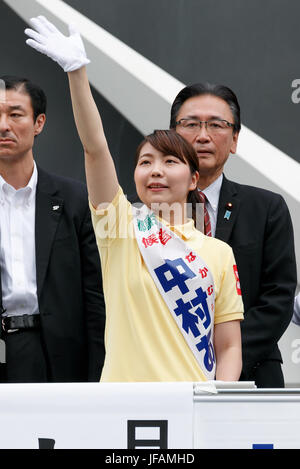 Tokyo, Japan. 1st July, 2017. Candidate Aya Nakamura waves to supporters during a campaign event for tomorrow's Tokyo Metropolitan Assembly election on July 1, 2017, Tokyo, Japan. A group of anti-Abe protesters appeared holding placards and chanting against the Prime Minister during the campaign event in support of LDP party candidate Aya Nakamura. Credit: Rodrigo Reyes Marin/AFLO/Alamy Live News Stock Photo