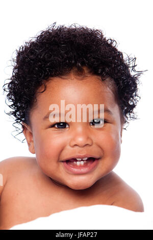 Happy smiling cute adorable teething baby face showing milk teeth, with curly hair. Stock Photo