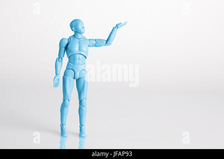 Blue male figurine standing on white reflective table holding one hand up. Making a decision concept with copy space Stock Photo