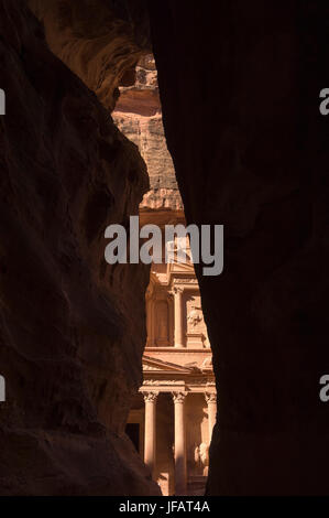 The Treasury (Al Khazneh) at the end of the Siq,  a narrow canyon leading to the Nabatean city of Petra. Stock Photo