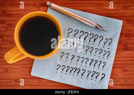 Question marks on a napkin. Close up. Stock Photo