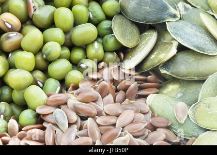 Close up of mung beans, linseeds (flax seeds) and pumpkin seeds, filling frame. Stock Photo