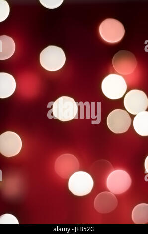 Bokeh lights with rich red background blending into darkness, portrait orientation. Stock Photo
