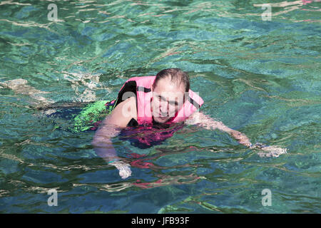 The man in the sea in a life jacket. Stock Photo