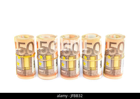 Rolls of euro bills in row on white Stock Photo