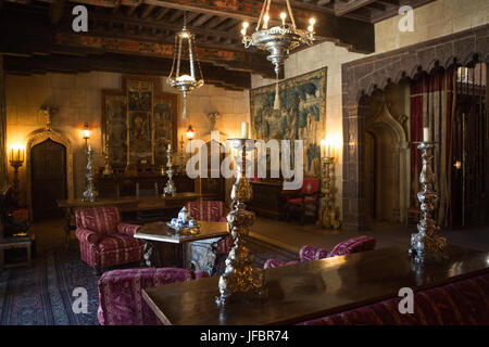 The Hearst Castle sitting room decorated with furniture, tapestries, artwork, ornate candles and light fixtures. Stock Photo