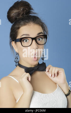 Cute girl in a bow tie poses faces. Stock Photo
