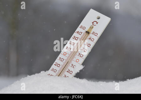 Thermometer in winter Stock Photo