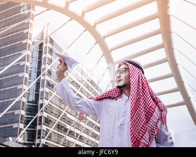 Young middle eastern businessman holding his rocket paper. Business people concept. Stock Photo