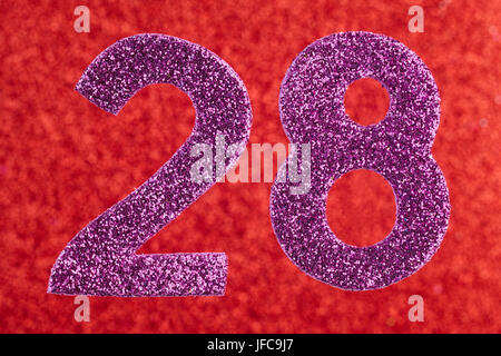 Number twenty-eight purple color over a red background. Anniversary. Horizontal Stock Photo