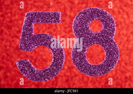 Number fifty-eight purple color over a red background. Anniversary. Horizontal Stock Photo