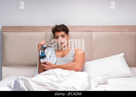 Man having trouble waking up in the morning Stock Photo