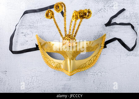 Gold carnival mask on a white background. Stock Photo