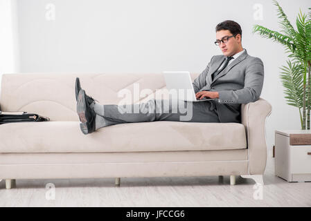Young businessman lying on the sofa Stock Photo