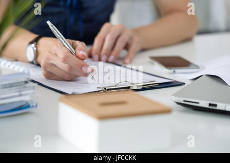 Close-up of female hands. Woman writing something  sitting at her office Stock Photo