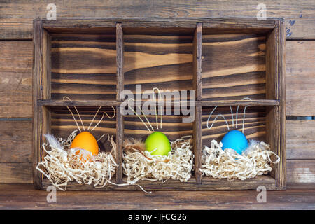 Easter eggs with bunny ears in the nests Stock Photo
