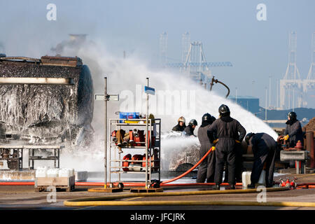 ROTTERDAM - MAR 2, 2011: Firefighters at a training exercise in the Port of Rotterdam. Stock Photo