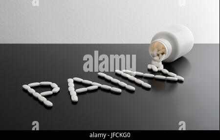 Pain killers spilling from bottle on table. Being in a lot of pain, suffering or relief concept. The word pain written with medicine coming out bottle Stock Photo