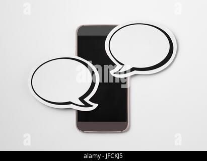 Speech bubbles on blank smartphone screen. Free copy space for text. Paper speech balloon and mobile phone on white background. Stock Photo