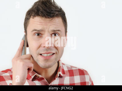 surprised man talking on his mobile phone and lookin at camera on white background. emotional concept Stock Photo
