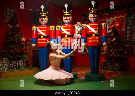 A ballerina performs in front of Christmas Nut Crackers, Stock Photo