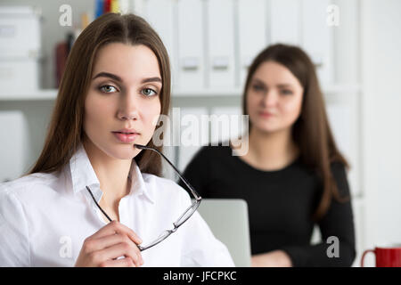 Two young business woman working at their office. Business education, partnership or cooperation concept Stock Photo