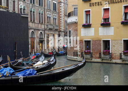 View of gondolas on the backside of Hotel Cavelletto from Bacino Orseolo on a rainy day, Venice, Italy Stock Photo