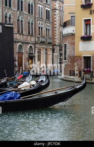 View of gondolas on the backside of Hotel Cavelletto from Bacino Orseolo on a rainy day, Venice, Italy Stock Photo