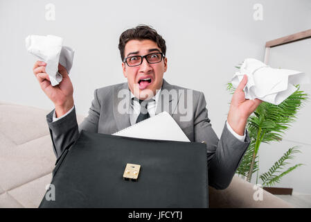 Angry businessman with crumbled paper Stock Photo