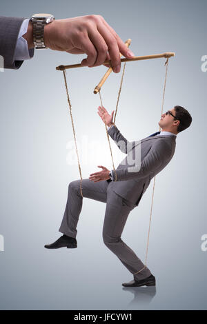 Businessman puppet being manipulated by boss Stock Photo