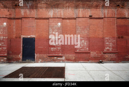 Empty street with old warehouse brick wall, industrial background, New York, USA. Stock Photo