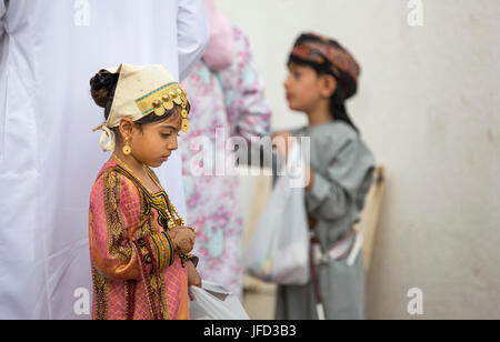 Nizwa, Oman - June 26th 2017: little girl choosing a toy market on a day of Eid al Fitr Stock Photo
