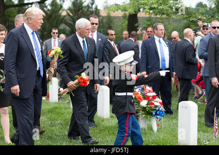 President Donald Trump and Vice President Mike Pence are guided by 6-year-old Christian Jacobs, son of fallen U.S. Marine Sgt. Christopher Jacobs, to his father’s grave during Memorial Day ceremonies, Monday, May 29, 2017, at the Arlington National Cemetery in Arlington, Va. (Official White House Photo by Shealah Craighead) Stock Photo