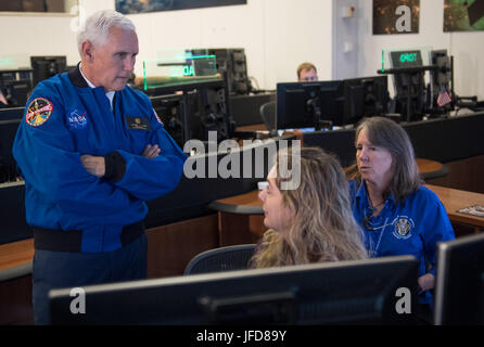 Vice President Mike Pence speaks with Ground controllers Karen Pisklak (left) and Laura Hoppe during a tour of the Christopher C. Kraft Jr. Mission Control Center, Wednesday, June 7, 2017 at NASA’s Johnson Space Center in Houston, Texas. The Vice President was at the space center to welcome America’s newest astronaut candidates, chosen from more than 18,300 applicants to carry the torch for future human space exploration. After completing two years of training, the new astronaut candidates could be assigned to missions performing research on the International Space Station, launching from Amer Stock Photo