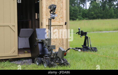 A Mini ANDROS II Robot, controlled by personnel assigned to Rapides Parish Sheriff’s Office, La., working together with Soldiers assigned to 705th EOD Company, 63rd EOD Battalion, 52nd EOD Group, 20th CBRNE Command, to move a safe containing explosives during Raven’s Challenge 2017 at Camp Shelby, Miss., June 29, 2017. Raven’s Challenge is an annual training event that provides Explosive Ordnance Disposal personnel and Public Safety Bomb Squads of both military and government agencies interoperability in a realistic domestic tactical environment. (U.S. Army photo by Sgt. Ashley Marble, 55th Si Stock Photo