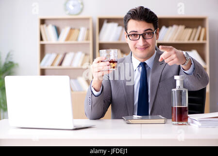 Young businessman drinking from stress Stock Photo