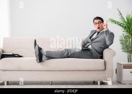 Young businessman lying on the sofa Stock Photo