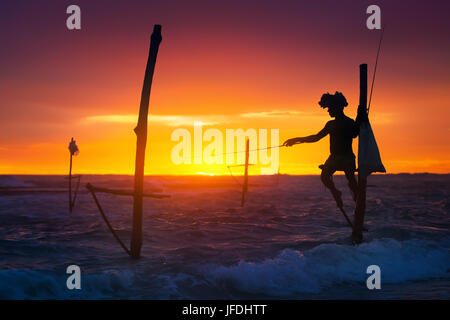 Sri Lanka's Stilt Fisherman. Fishing on stilt is very common in many Asian countries, but most of all - in Sri Lanka, in the Ahangama village. Stock Photo