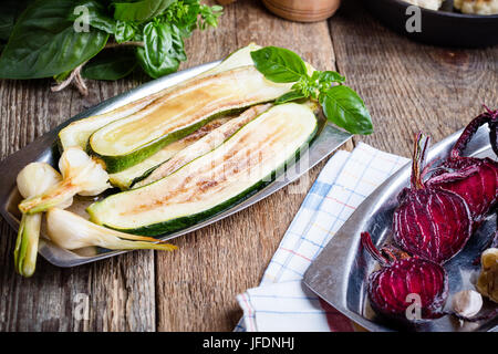 Sliced beetroot and zucchini  on rustic outdoor party table.  Variety of roasted vegetables, diet and  healthy eating food concept Stock Photo