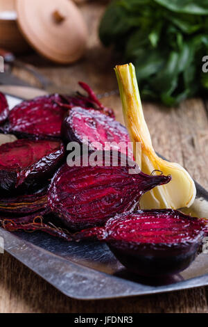 Sliced baked beetroot on rustic outdoor party table, diet and  healthy eating food concept Stock Photo
