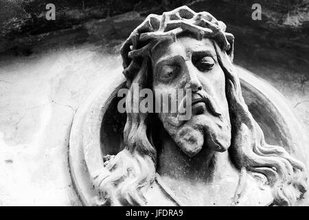 Face of Jesus Christ on old tombstone. Black and white image Stock Photo