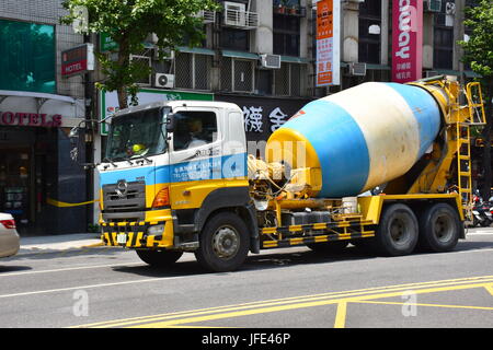 This three color cement truck was passing by the Mackay hospital and I had to get its photo. Its barrel was turning and taking a fresh load to a site. Stock Photo