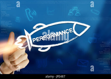 business hand clicking performance rocket with blurred background Stock Photo
