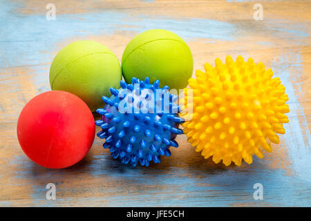 self massage and reflexology therapy concept - a set of small rubber balls Stock Photo