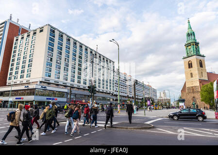 Berlin, Germany - April 13, 2017: Street with the St Mary church (Marienkirche) in the background and people passing through the pedestrian crossing i Stock Photo