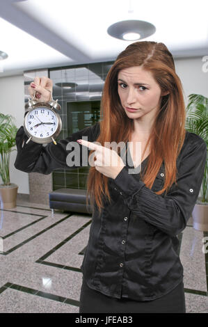 Woman with alarm clock Stock Photo