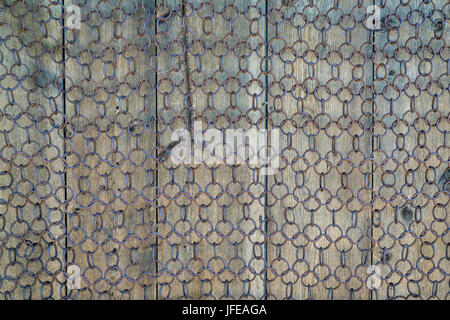 background and texture of vintage chain mesh against weathered wood Stock Photo