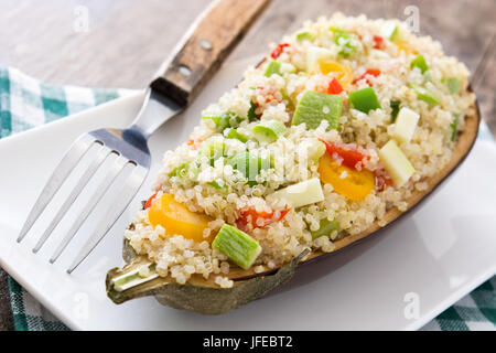 Stuffed eggplant with quinoa and vegetables on wooden table Stock Photo ...