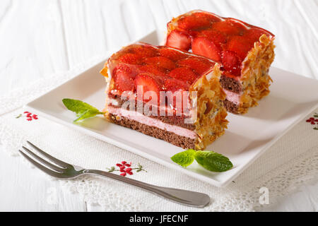 Beautiful strawberry jelly cake with almonds close-up on a plate. horizontal Stock Photo