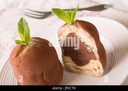 Delicious sliced rum balls with filling, close-up on a plate on a table. horizontal Stock Photo